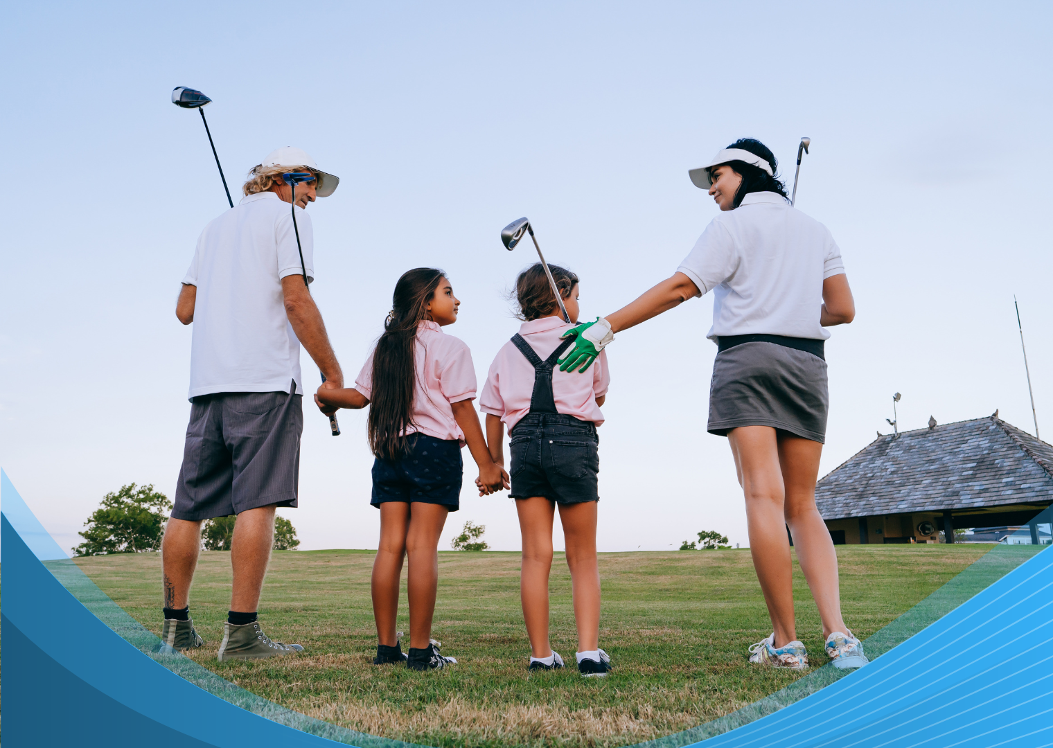 A family of four standing together on a golf course while holding golf clubs.