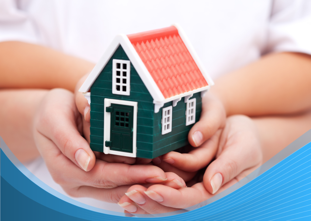 Hands protecting small house model